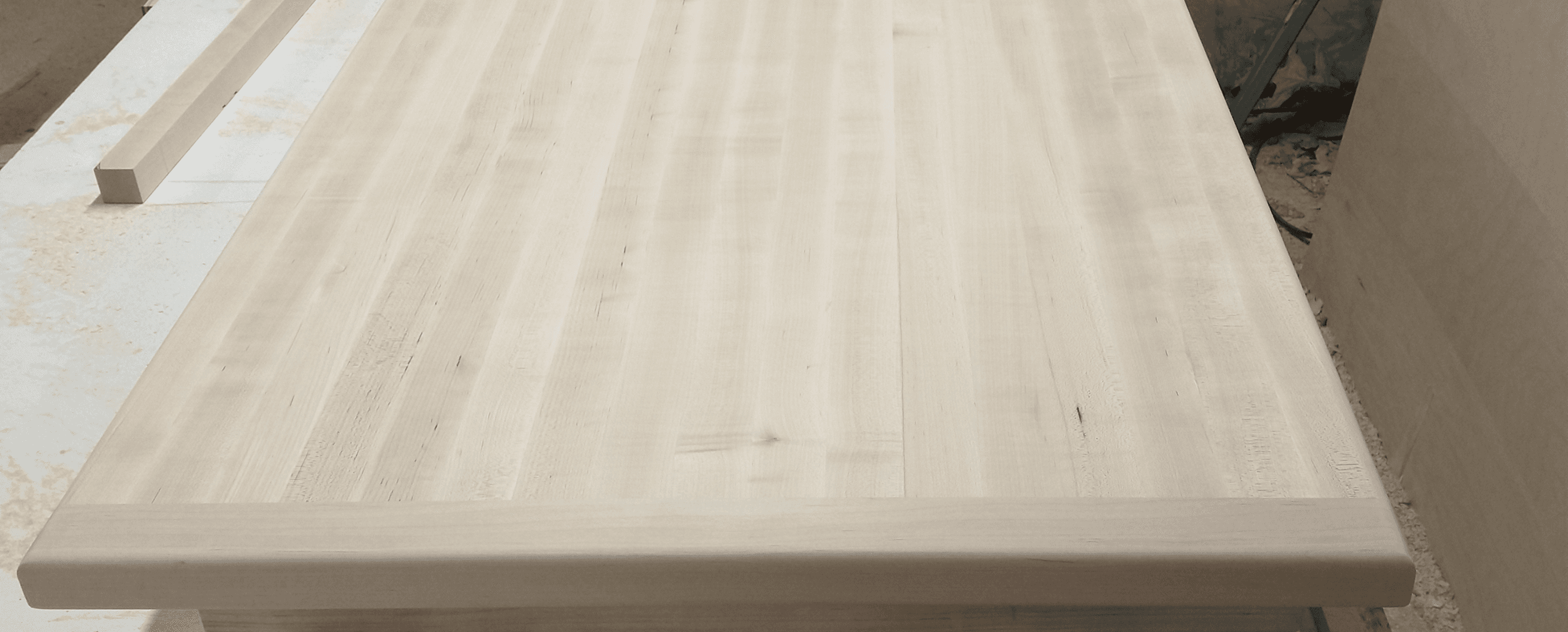Workshop bench covered with freshly planed timber